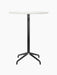 Front view of the Harbour Column Bar Table with a round, Estremoz marble top, a slender black column, and a black star base.