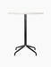 A front view of the Harbour Column Counter Table, featuring a round Estremoz marble top and a black, four-legged star base.