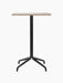 A front view of the Harbour Column Counter Table, featuring a rectangular Kunis Brescia tabletop and a black star base.