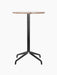 Front view of the Harbour Column Counter Table with a round Kunis Breccia stone top and a slim black star base.
