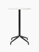 Front view of the Harbour Column Counter Table, featuring a round, white Estremoz marble top and a slim black star base.