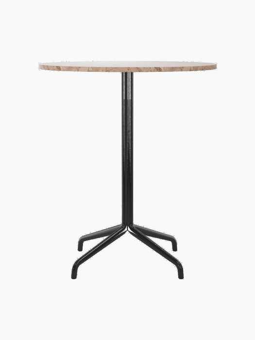 A front view of the Harbour Column Counter Table, featuring a round Kunis Breccia stone top and a black metal star base.