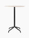 The Harbour Column Counter Table, shown from the front with a round, light-coloured top and a slender black star-shaped base.