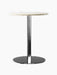 Harbour Column Dining Table with a round off-white marble top, a slender black column and a flat round black base.