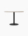 Front view of the Harbour Column Dining Table with a round Kunis Breccia stone top and a black metal column on a round base.