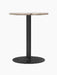Front view of the Harbour Column Dining Table with a round Kunis Breccia stone top, a slim black metal column and base.