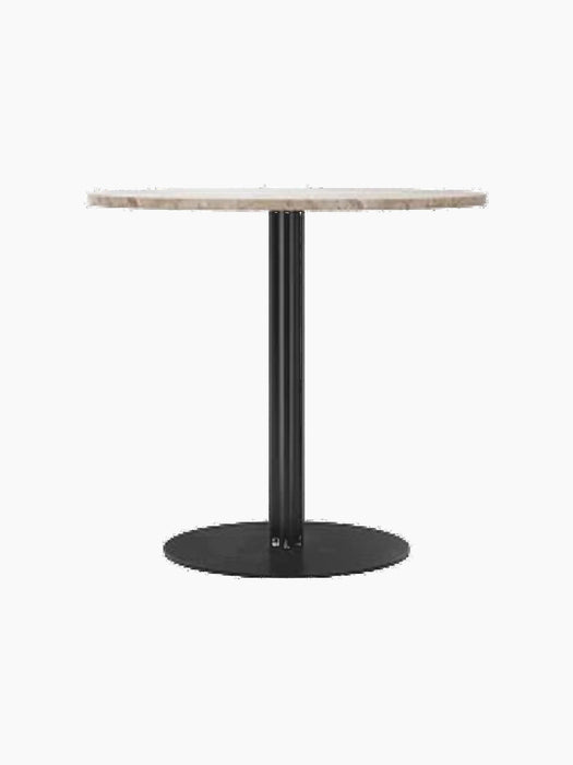 Harbour Column Dining Table with a round Kunis Breccia stone top on a slender black pedestal with a circular base.