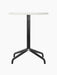Front view of the Harbour Column Dining Table with a round Estremoz marble top and a slender black column with a star base.