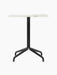 Front view of the Harbour Column Dining Table. It has a rectangular white Estremoz marble top and a black star base.