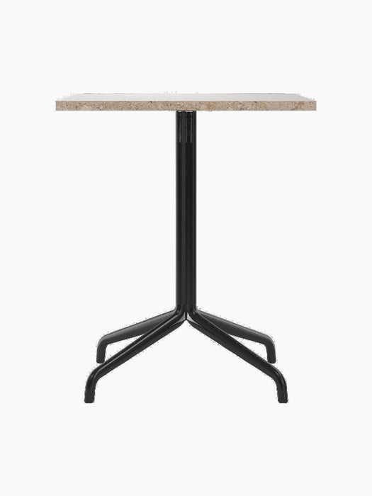 Front view of the Harbour Column Dining Table featuring a rectangular Kunis Brescia stone top and a black metal star base.