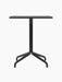 Front view of the Harbour Column Dining Table with a rectangular black oak top and black starbase against a plain background.