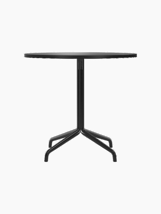 A front view of the Harbour Column Dining Table, featuring a round charcoal linoleum top and a slender black metal star base.