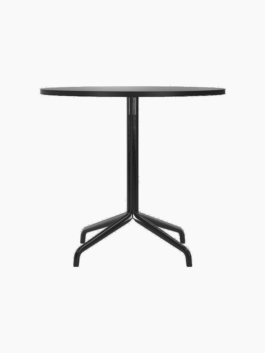 A front-on photograph of the Harbour Column Dining Table, featuring a round top in black oak and a slender, black starbase.