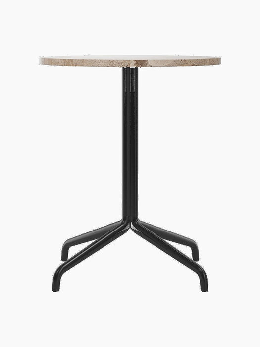A front view of the Harbour Column Dining Table, featuring a round Kunis Breccia stone top and a black four-legged star base.