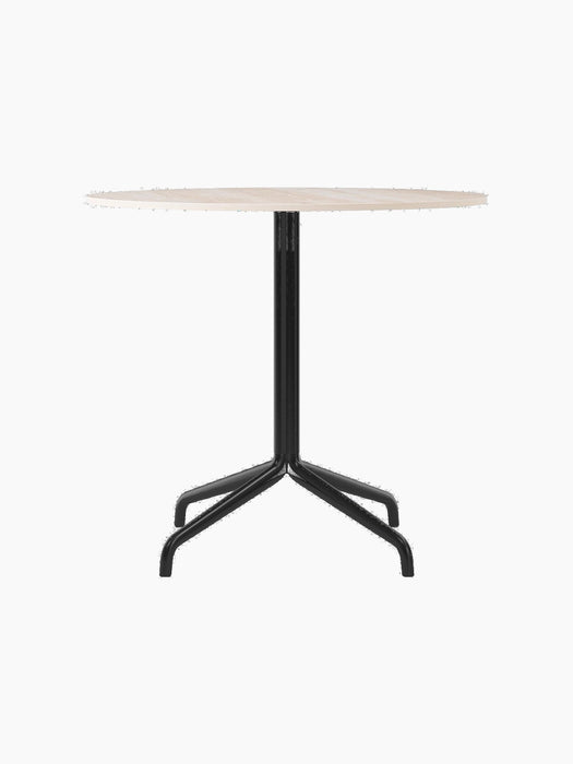 Harbour Column Dining Table, featuring a round Kunis Breccia stone top and a black powder-coated steel star base.