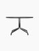 Harbour Column Lounge Table with a round black oak top and a black star-shaped base against a black background.