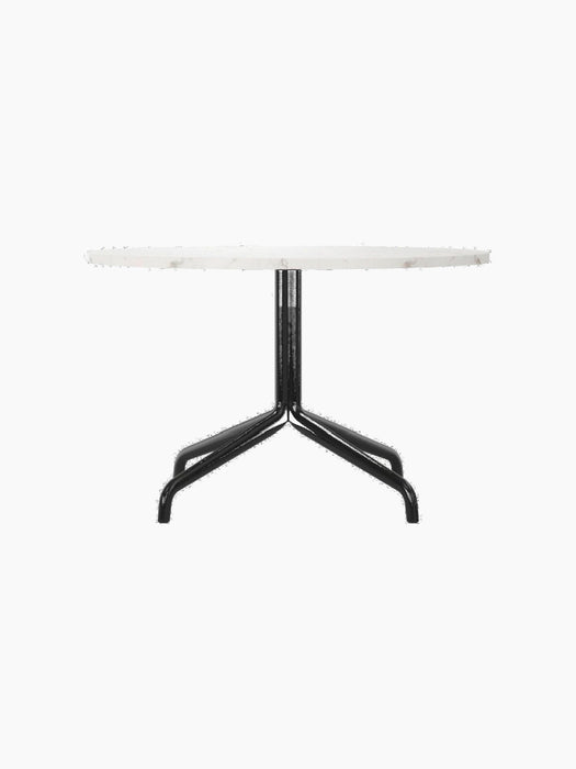 Harbour Column Lounge Table with a round white Estremoz marble top and a black star-shaped metal base, shown from the side.