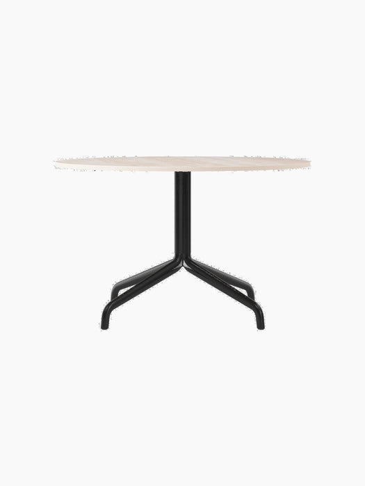 A front view of the Harbour Column Lounge Table with a round, light-coloured tabletop and a slim, black star-shaped base.