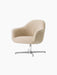 An angled view of the Harbour Lounge Chair, with light beige bouclé upholstery and a polished aluminium star swivel base.