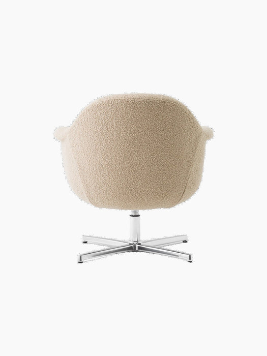 Back view of the Harbour Lounge Chair upholstered in a beige textured fabric with a polished aluminium star swivel base.