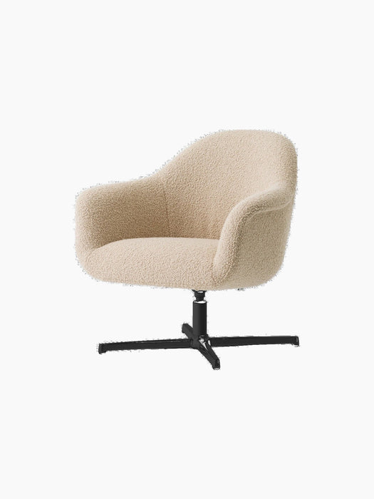 Angled view of the Harbour Lounge Chair with a textured, light beige upholstered shell and a black, star-shaped swivel base.