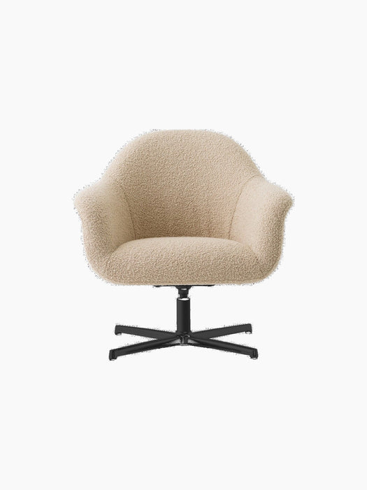Front view of the Harbour Lounge Chair upholstered in light beige bouclé fabric with a black star swivel base.