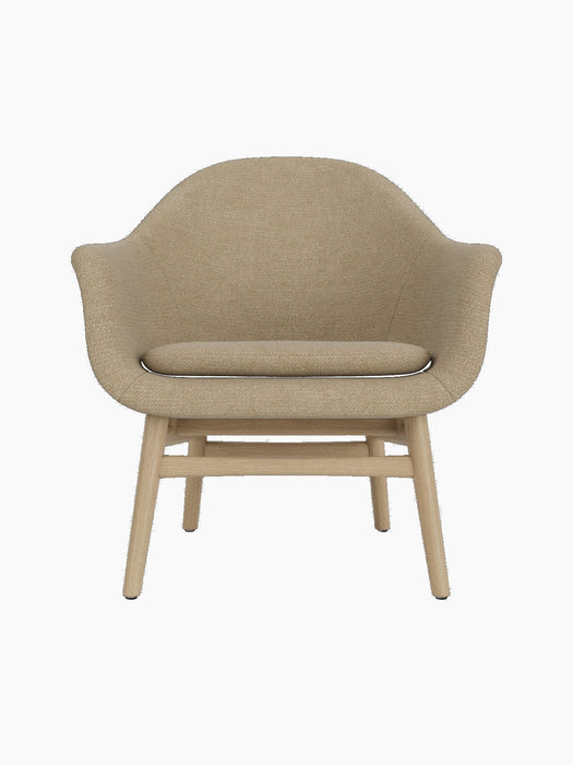 Front view of the Harbour Lounge Chair, featuring a natural oak frame and upholstered in a light beige Audo Bouclé 02 fabric.