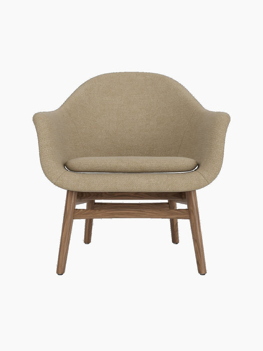 A front-facing view of the Harbour Lounge Chair, upholstered in light brown Audo Bouclé 02 fabric on a solid walnut frame.
