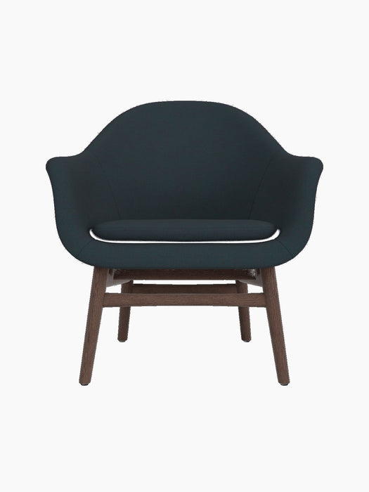 Front view of the Harbour Lounge Chair, upholstered in dark blue Fiord 981 fabric with a dark stained oak frame.