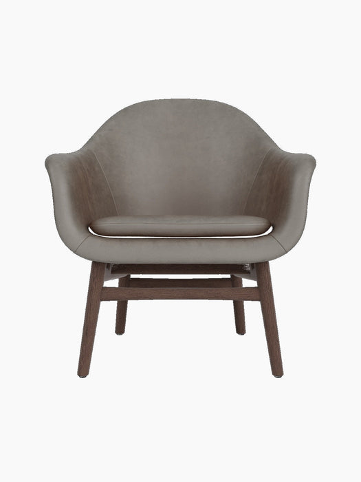 Front view of the Harbour Lounge Chair, featuring light brown Dakar 0311 upholstery and a sculptural dark stained oak frame.