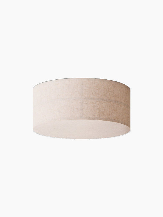 The cylindrical Hashira Ceiling Lamp in a raw linen finish, photographed from a low angle against a solid black background.