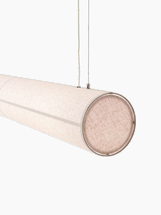 A close-up, angled view of the illuminated Hashira Linear Pendant Lamp, showing the textured raw linen shade and end cap.