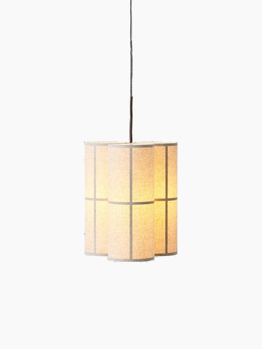 Hashira Pendant Lamp, Cluster, a trio of illuminated cylindrical pendants in raw linen, hanging against a black background.