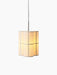 Hashira Pendant Lamp, Cluster, a trio of illuminated cylindrical pendants in raw linen, hanging against a black background.