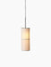 A lit Hashira Pendant Lamp with a cylindrical raw linen shade hangs against a black background, showing its inner structure.