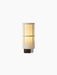 Illuminated Hashira Portable Table Lamp with a cylindrical raw linen shade featuring a grid pattern, on a dark wood base.