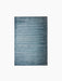 A top-down view of the Houkime Rug in Midnight Blue, highlighting its horizontal ribbed texture against a black background.