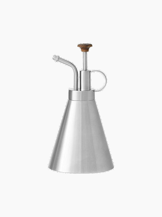 The Hydrous Plant Mister, a stainless steel sprayer with a conical body, a curved spout, and a wooden pump handle.