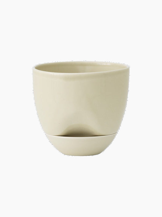 Front view of the Hydrous Planter in a pale Ashen colour. The ceramic planter has a rounded bowl shape and a matching saucer.