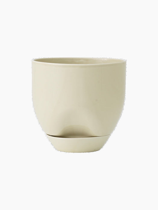 Front view of the Hydrous Planter in Ashen. The rounded, glossy planter has a subtle indent and matching saucer.