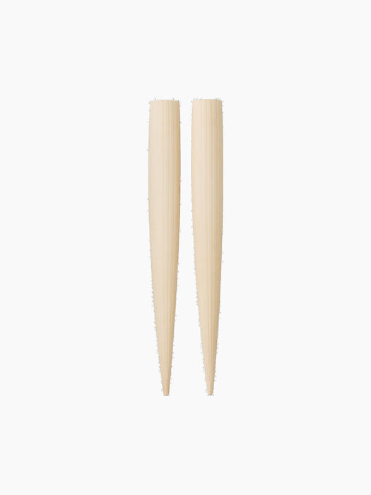A pair of cream-coloured Hydrous Watering Sticks with a ridged texture, tapering to a point, against a black background.
