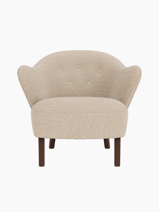 Front view of the Ingeborg Lounge Chair in textured beige fabric, with a button-tufted back and smoked oak legs.