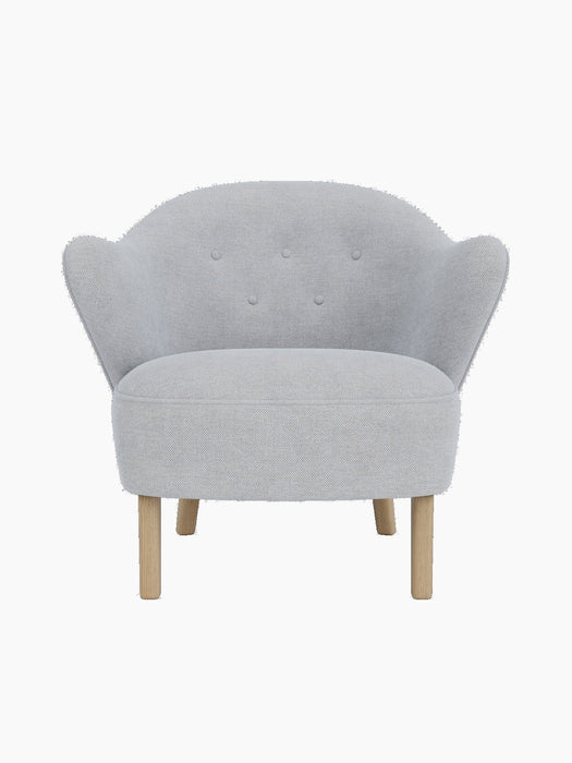 Front view of the Ingeborg Lounge Chair, featuring a light grey Fiord 751 textile upholstery and four natural oak legs.