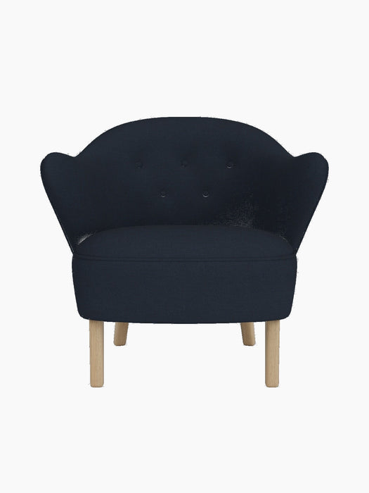 Front view of the Ingeborg Lounge Chair in dark navy Fiord 782, with a button-tufted backrest and natural oak legs.