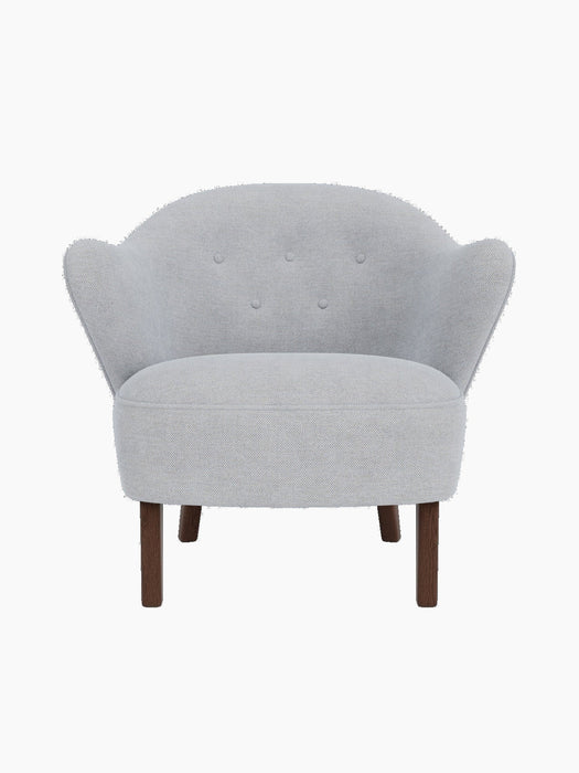 Front view of the Ingeborg Lounge Chair in a light grey fabric with four tufted buttons and dark stained oak legs.