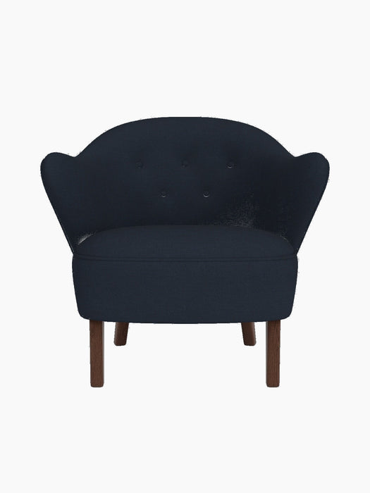 Front view of the Ingeborg Lounge Chair in dark blue Fiord 782 textile, featuring a tufted back and dark smoked oak legs.