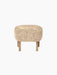 A front-facing view of the Ingeborg Ottoman. It has a fluffy, honey-coloured sheepskin top and four light oak legs.