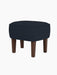 The Ingeborg Ottoman, upholstered in dark blue Fiord 782 fabric with smoked oak legs, shown against a plain black background.