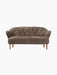 Front view of the Ingeborg Sofa in textured, brown Sahara sheepskin, featuring a button-tufted back and light oak legs.