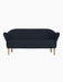 A front-on view of the Ingeborg Sofa. It features dark blue button-tufted upholstery, curved armrests, and natural oak legs.